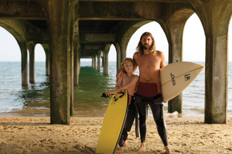 Father and son with surf boards