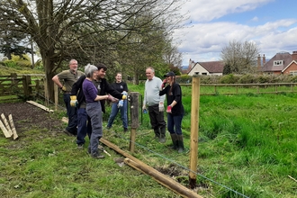 Volunteers laughing after the strength of the post rammers brought it too low!