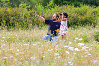 A man and child birdwatching