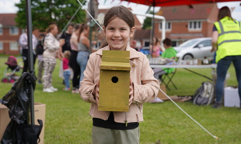 Girl holding bird box at a wildlife festival
